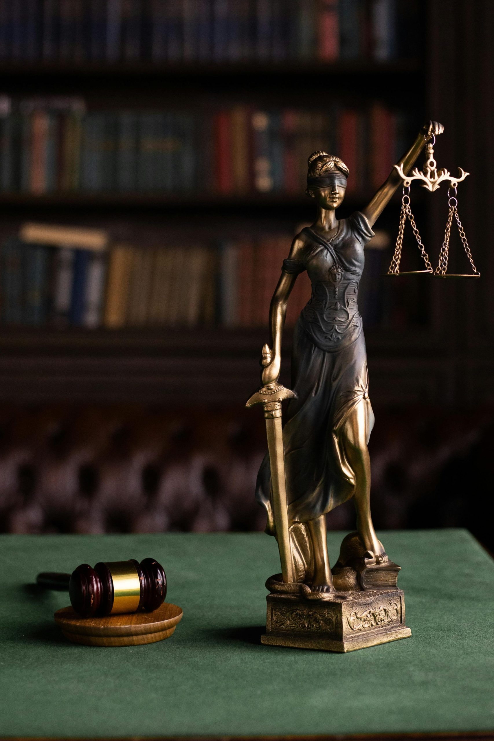pexels photo 6077123 6077123 Lady Justice and gavel on a table in a classic law library setting.